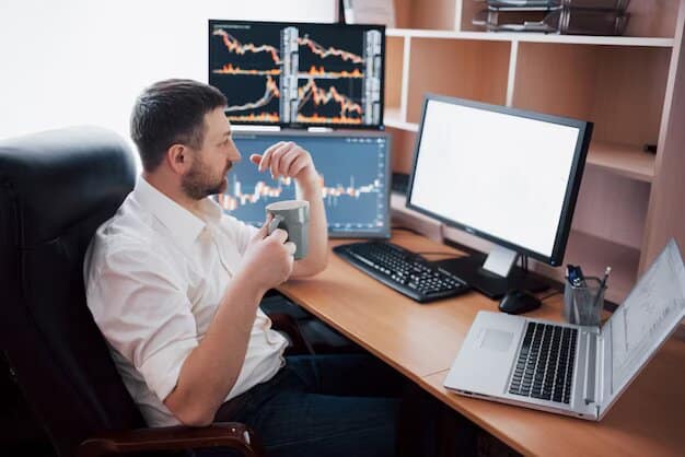 Der beste Trading-Computer: Alles, was Sie für den Einstieg wissen müssen Das Bild zeigt einen Mann am Schreibtisch sitzen. Auf dem Schreibtisch ist ein Trading-Setup mit mehreren Bildschirmen